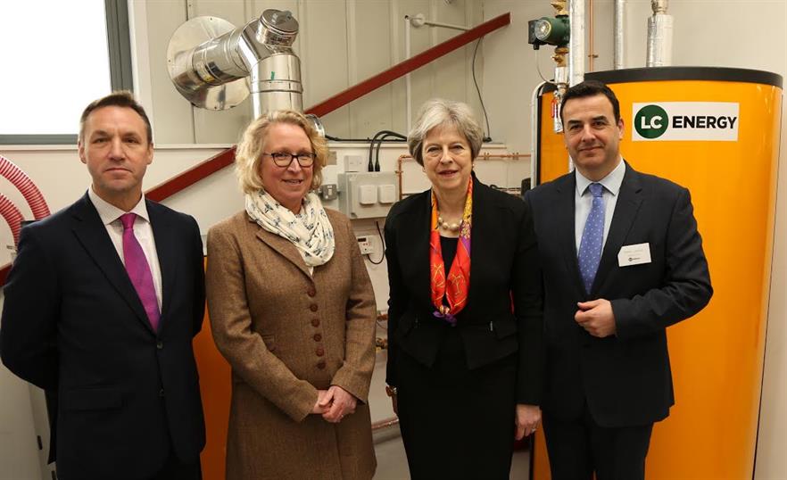 PM Theresa May (third from left) opens the new facility