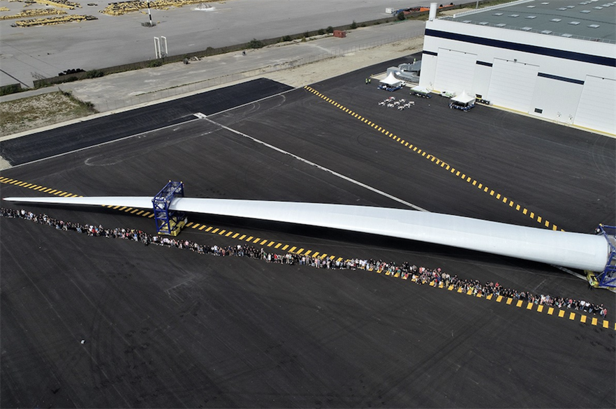 LM Wind Power employees with a 107-metre blade at the manufacturer's facility in Cherbourg, France