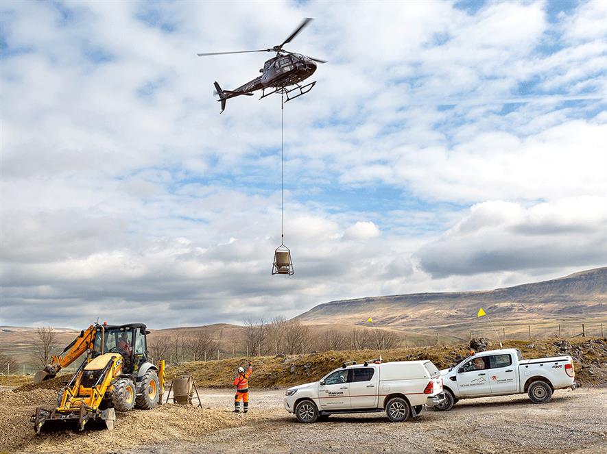 Aggregate to build the 1.3km path through part of the Three Peaks walking route is being brought in by helicopter. Photograph: Hanson