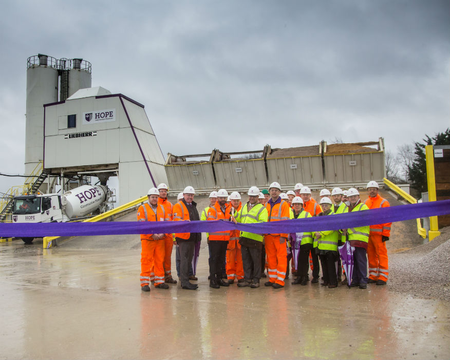 Local MP Alok Sharma (front row centre) cuts the ribbon to the new depot. Picture: Hope