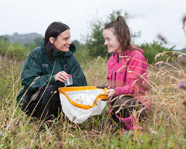 Ranger and local resident identify bugs on site. Photograph Land Trust