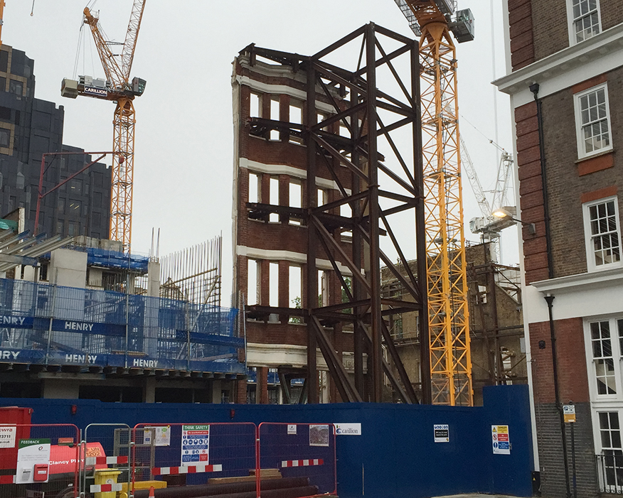 Construction in London has thrived, including building modern apartments behind old facades. Photograph: Matt Brown