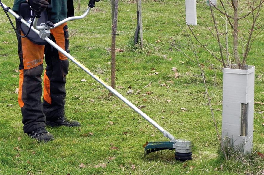 Man cutting grass with line trimmer