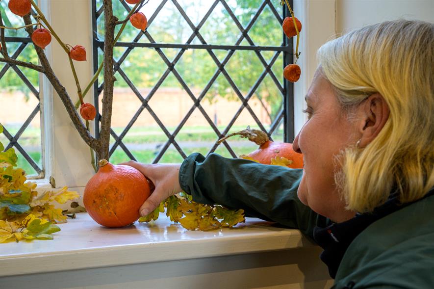 Ham House's head gardener Rosie Fyles puts the finishing touches to her autumn window display - credit Chris Davies