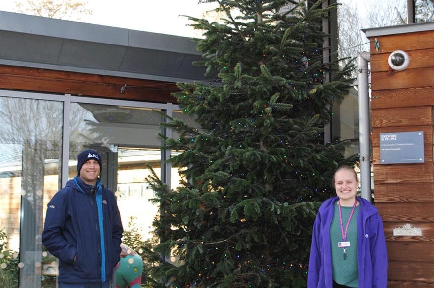 Staff with a Christmas tree donated by ICL