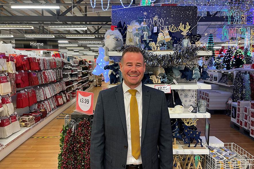 QD Stores trading director James Collins in front of Christmas products in store