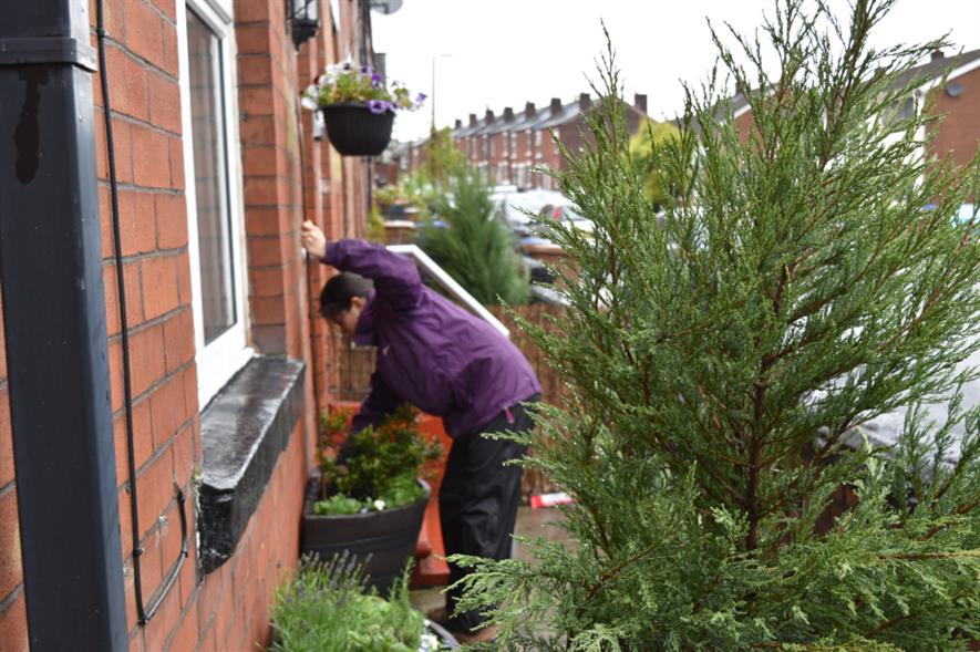Researcher installing trellis in the newly planted front garden - credit: Anna Da Silva/RHS images