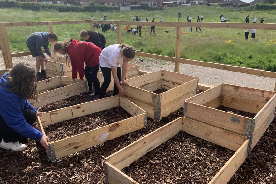Students putting out raised beds - credit: Green-tech