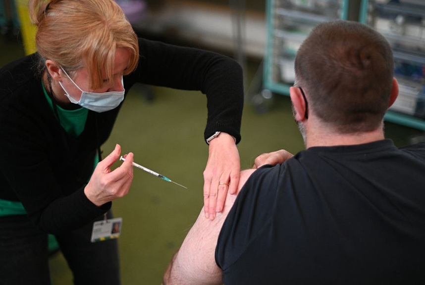 A man receiving a Pfizer COVID-19 booster vaccination