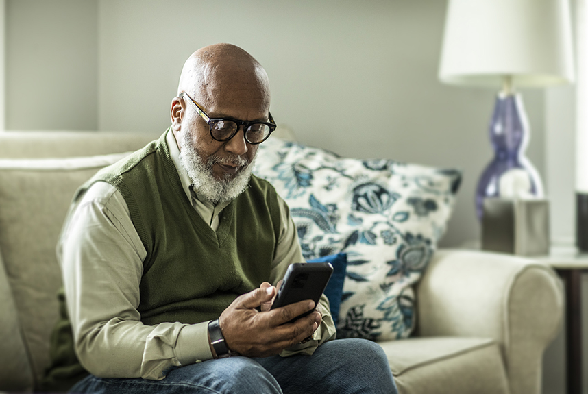 An elderly man using a smart phone