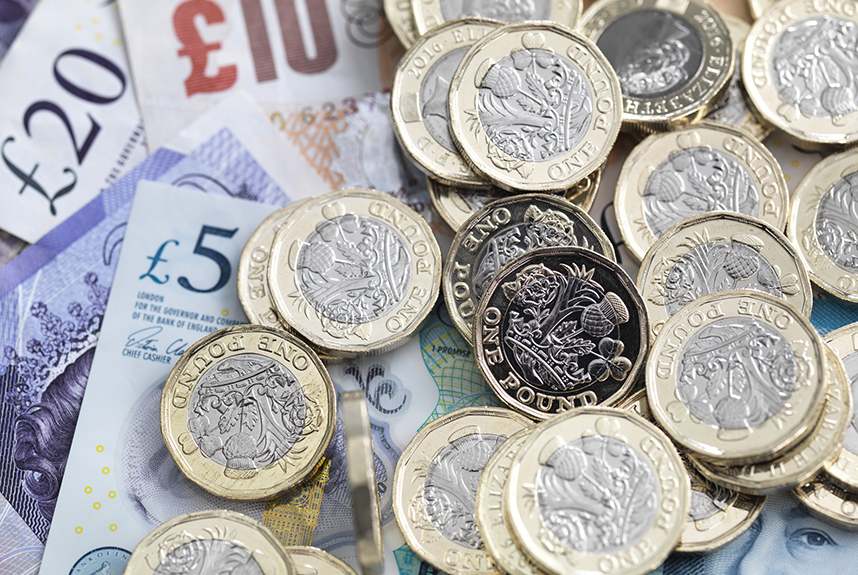 Pile of pound coins and bank notes