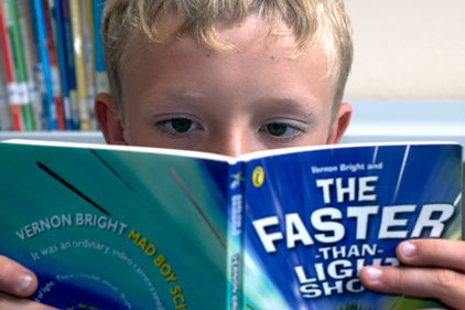 Absorbing read: a young boy is engrossed in a book