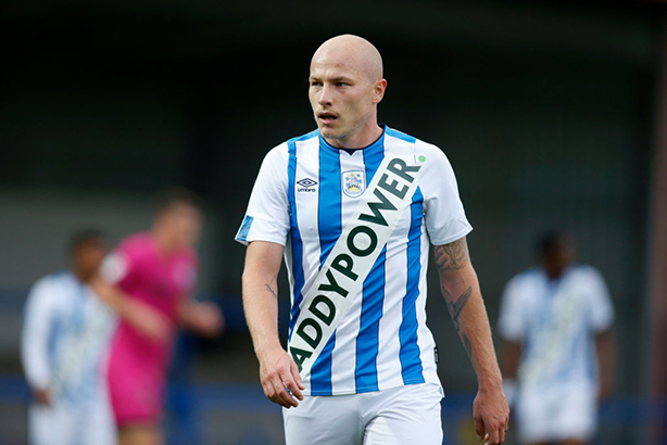 Australian international Aaron Mooy sports a fake Huddersfield kit in a friendly with Rochdale. (Photos by John Early/Getty Images)