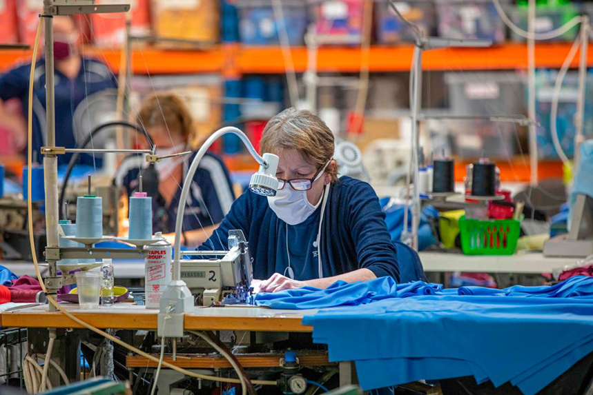 O'Neills sportswear staff making NHS scrubs. A quarter of Britons are more likely to buy from brands helping out. (Photo: Getty Images) 
