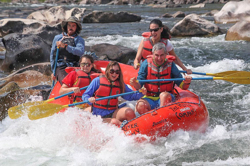 Richard Edelman and his three daughters ride the rapids.
