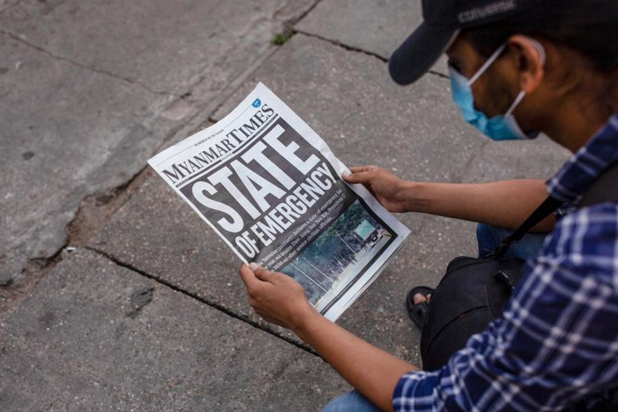 A man reading the national headline a day after Myanmar's military detained the country's de facto leader Aung San Suu Kyi and the country's president in a coup. (Getty Images)