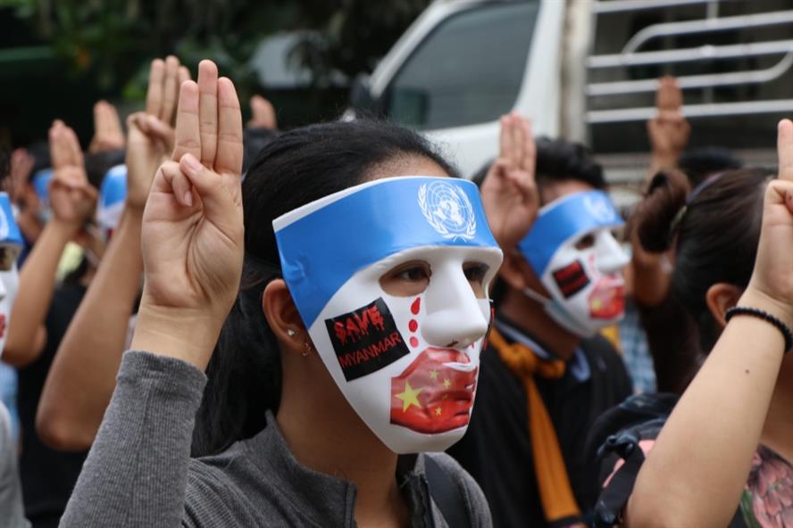 People, with their masks, stage a demonstration to protest against the military coup in Yangon on April 4 (Getty Images)