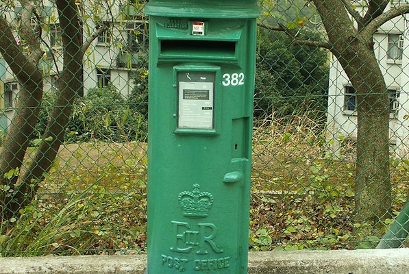 A cast-iron postbox with the UK royal insignia in Hong Kong