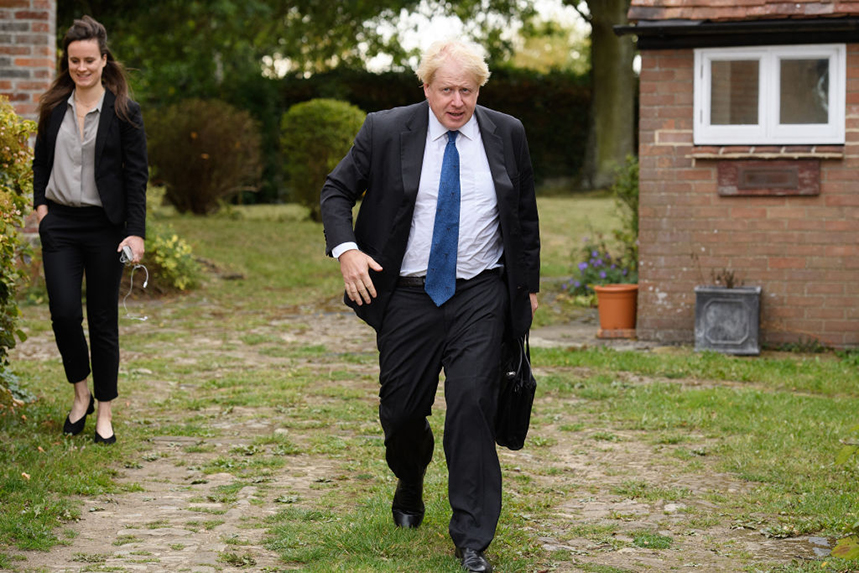 Boris Johnson leaves his home alongside Mimi Randolph, an employee of CTF Partners, in 2018 (©Leon Neal/Getty Images)