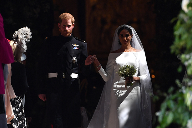 The new Duke and Duchess of Sussex emerge from the West Door of St George's Chapel, Windsor Castle (Credit: AFP Photo/Pool AND AFP Photo/Ben Stansall)