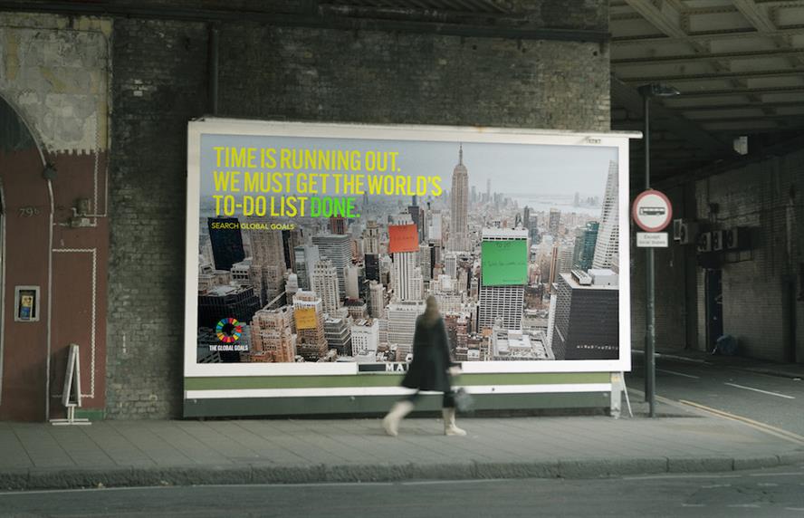 Pedestrian walks past steet-level Project Everyone billboard