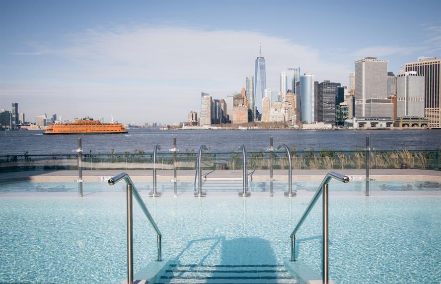 View of Manhattan skyline from a pool at QC NY Spa on Governors Island
