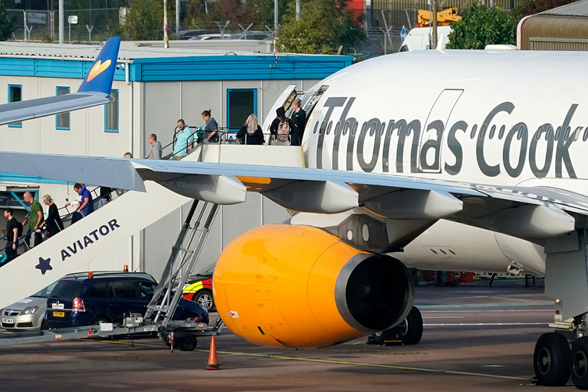 Passengers disembark a Thomas Cook plane in Manchester after the travel operator went bankrupt. (Photo by Christopher Furlong/Getty Images)