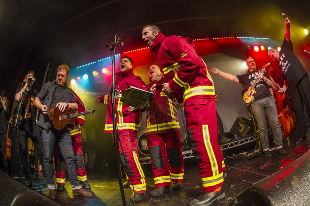 The band with members of Red Watch performing 'Chip Pan' last December