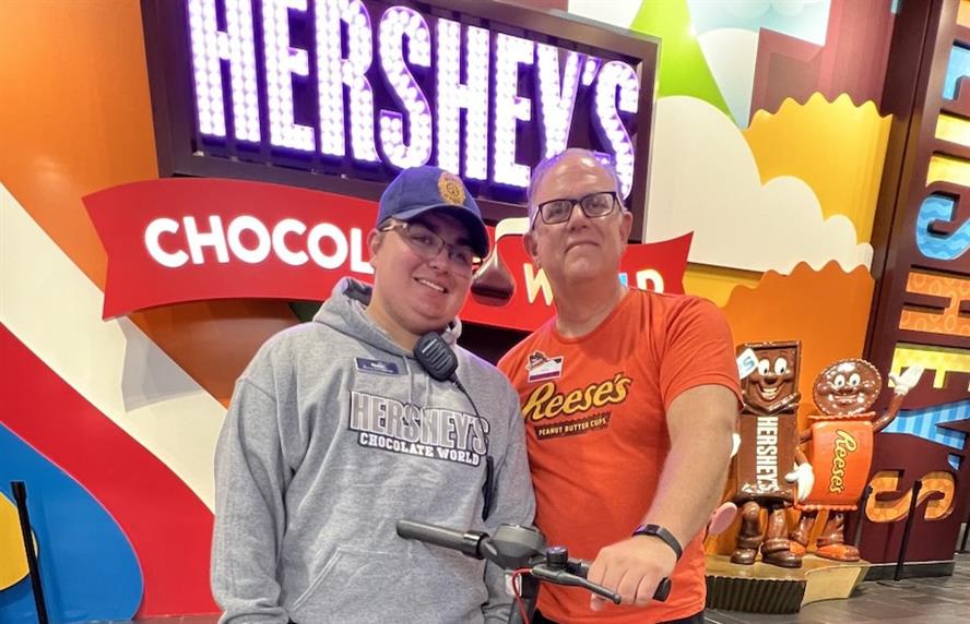 Picture of Owen, one of Hershey Chocolate World’s security guards, and marketing manager Todd Koh