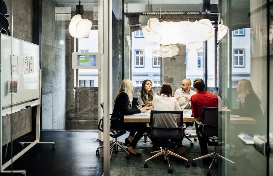 Employees sitting at office table