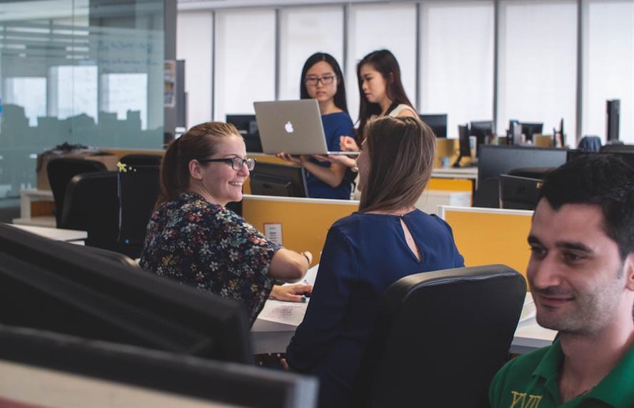 Happy diverse workers working in an office