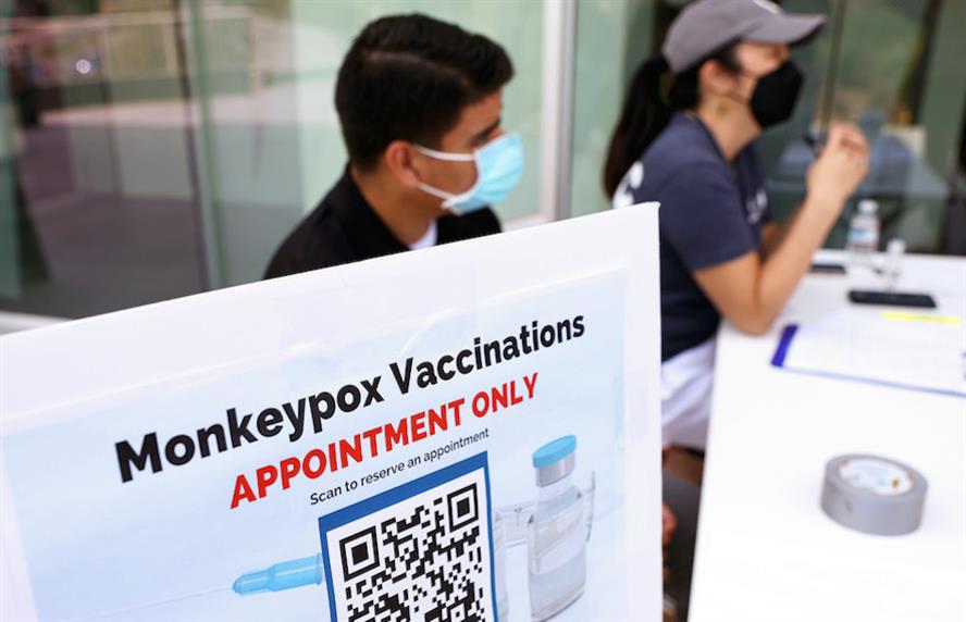 Two healthcare workers at a monkeypox vaccination table