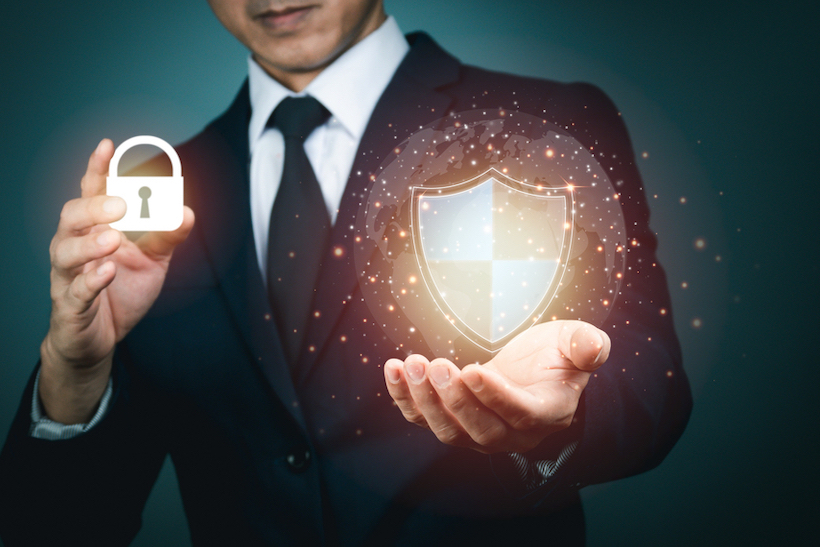 Stock image of man holding CGI icons of a lock and a shield