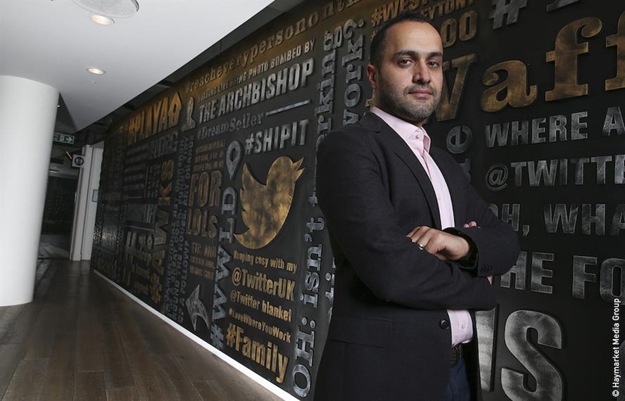 Dara Nasr in front of a wall full of tweets