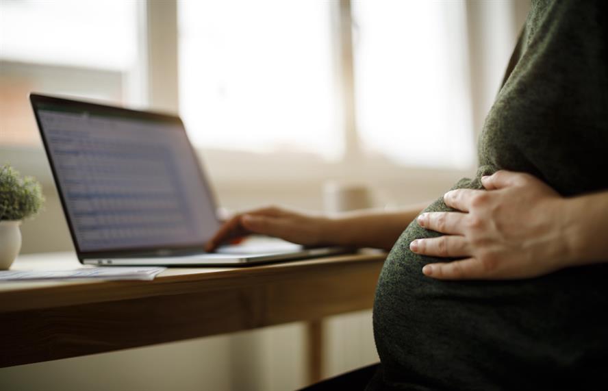 Stock image of a pregnant woman using a computer