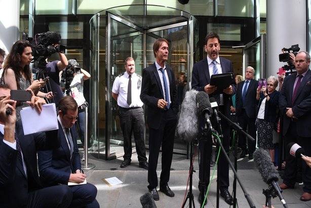 Sir Cliff Richard and his solicitor, Gideon Benaim, outside the Rolls Building of the High Court in London after the singer won his court case against the BBC
