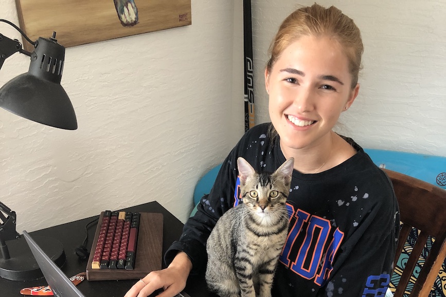 Sam and her new kitten, Rio, in her home office. 