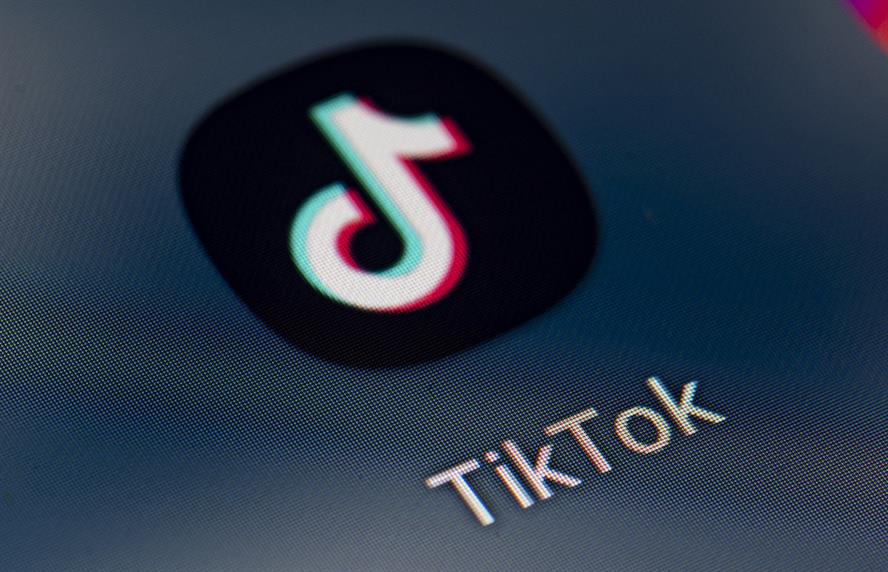 TikTok app icon on cell phone screen