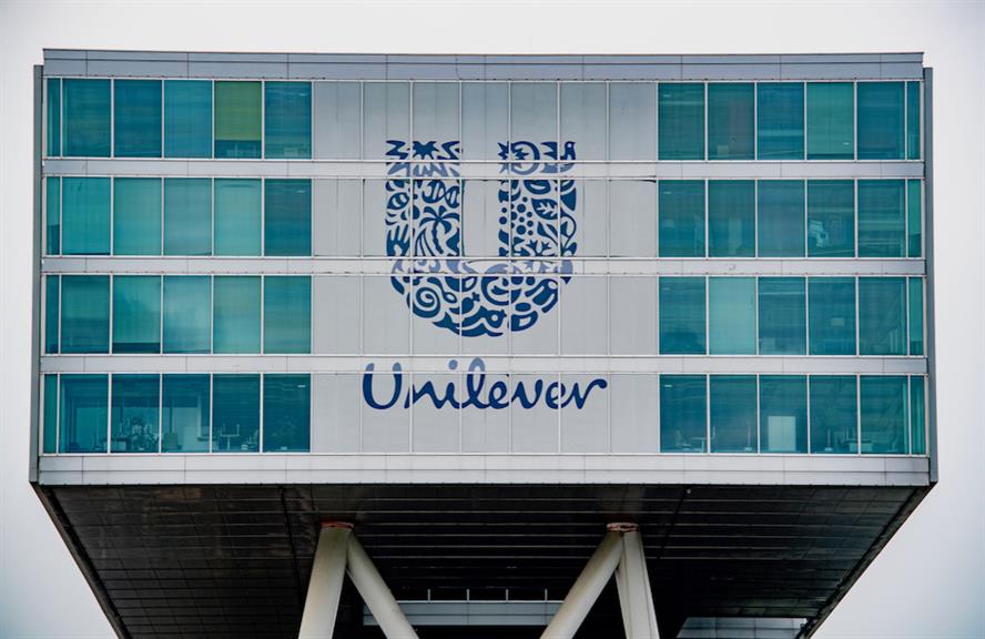 The Unilver logo on the front of a glass-fronted office building