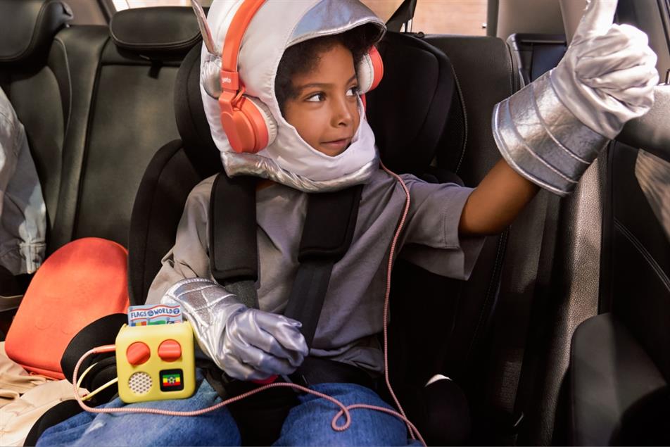 Child in car listening to Yoto